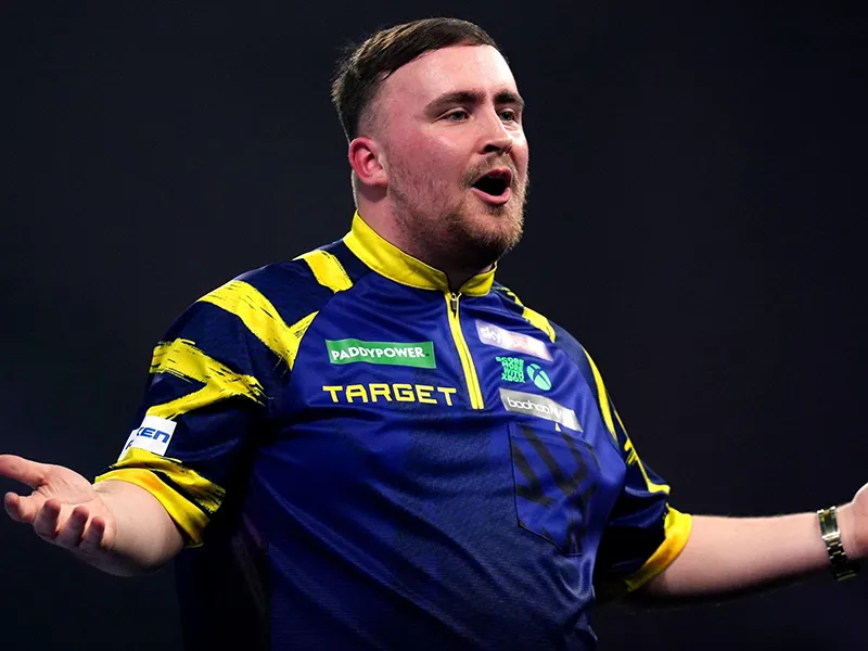 Luke Littler celebrating a win on the PDC stage
